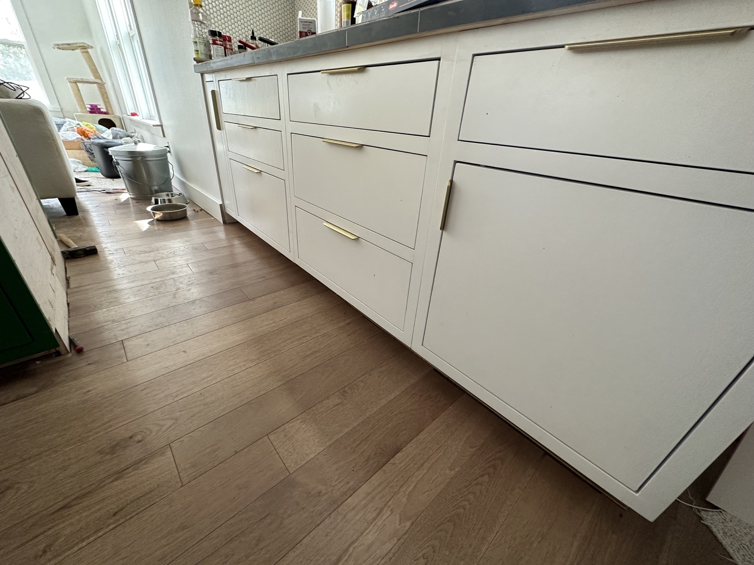 White custom cabinet doors and drawers with gold-tone handles