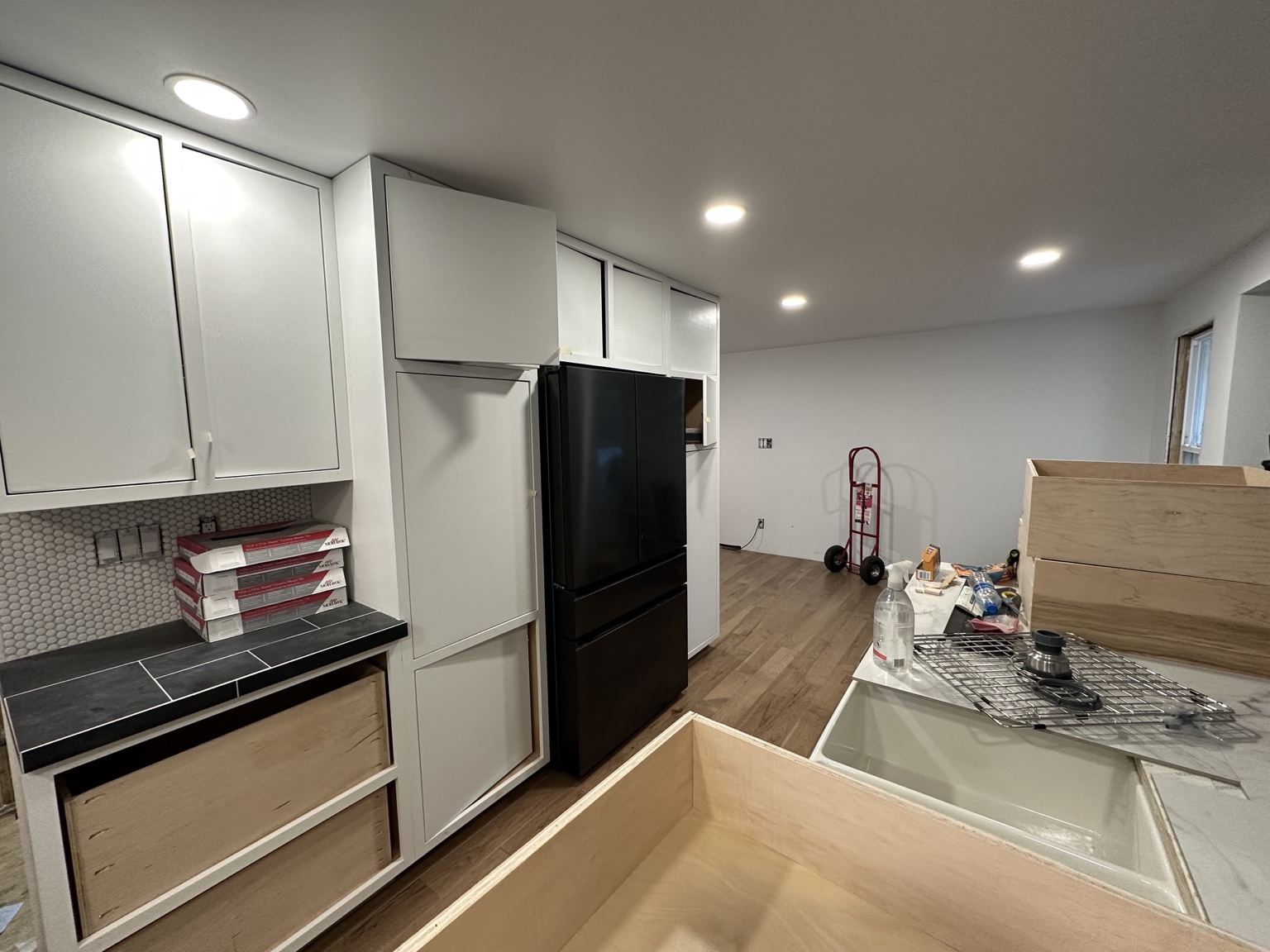 Cabinet doors and refrigerator surround in progress